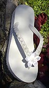 white bridal flip flops with satin flower and pearls